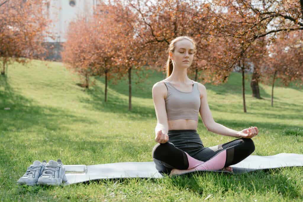 Beginner practicing mindfulness meditation for anxiety relief in nature